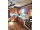 Well-lit kitchen with wood cabinets, granite countertops, and stainless steel oven at 956 S Deshon Rd, Lithonia, GA 30058