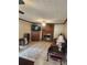 Comfortable living room featuring a brick fireplace and neutral colored tile floors at 956 S Deshon Rd, Lithonia, GA 30058