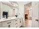 Bright bathroom featuring double sink vanity with modern fixtures and an open doorway to the bedroom at 2510 Thorngate Dr, Acworth, GA 30101