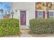 Entry to townhome with a storm door flanked by lush green bushes at 2510 Thorngate Dr, Acworth, GA 30101