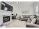 Cozy living room featuring fireplace, TV, and comfortable gray sectional at 2510 Thorngate Dr, Acworth, GA 30101