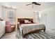 Main bedroom featuring tray ceiling, ceiling fan, natural light, and luxury vinyl flooring at 2510 Thorngate Dr, Acworth, GA 30101