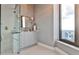 Modern bathroom featuring glass shower, marble vanity, and large window with city views at 3376 Peachtree Ne Rd # 56, Atlanta, GA 30326