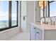 Bright bathroom features a vanity with gold faucet and a large window with cityscape view at 3376 Peachtree Ne Rd # 56, Atlanta, GA 30326