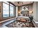 Bedroom features large windows, a chandelier, hardwood floors, and a comfortable bed at 3376 Peachtree Ne Rd # 56, Atlanta, GA 30326