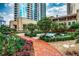 Lush courtyard with a brick pathway, a decorative fountain, and surrounded by flowering plants at 3376 Peachtree Ne Rd # 56, Atlanta, GA 30326