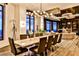 Bright dining room featuring modern lighting, long table with seating for ten, and views from large windows at 3376 Peachtree Ne Rd # 56, Atlanta, GA 30326