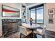 Elegant dining area with a marble fireplace, modern art, and a scenic view from the large window at 3376 Peachtree Ne Rd # 56, Atlanta, GA 30326