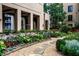 A charming garden features a stone pathway, lush greenery, and serene ambiance at 3376 Peachtree Ne Rd # 56, Atlanta, GA 30326