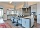 Stylish kitchen featuring a large island with seating, modern appliances, and unique pendant lights at 3376 Peachtree Ne Rd # 56, Atlanta, GA 30326