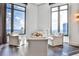 Bright living room featuring white sofas, large windows with city views and hardwood floors at 3376 Peachtree Ne Rd # 56, Atlanta, GA 30326