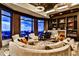 Expansive living room with floor-to-ceiling windows, a grand piano, and custom built-in bookshelves with a fireplace at 3376 Peachtree Ne Rd # 56, Atlanta, GA 30326