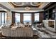 Modern living room with a curved sofa, floor-to-ceiling windows offering city views, and stylish circular chandeliers at 3376 Peachtree Ne Rd # 56, Atlanta, GA 30326