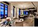 Open living and dining space with large windows, hardwood floors, modern lighting, and a stylish dining table set at 3376 Peachtree Ne Rd # 56, Atlanta, GA 30326