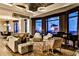 Open-concept living area featuring a grand piano, city views, fireplace, hardwood floors, and stylish furnishings at 3376 Peachtree Ne Rd # 56, Atlanta, GA 30326