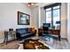 Home office boasts a modern window, a classic desk, and refined decor with a leather couch at 3376 Peachtree Ne Rd # 56, Atlanta, GA 30326