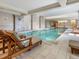 Beautiful indoor pool with lounge chairs, ample natural light, and modern design elements at 3376 Peachtree Ne Rd # 56, Atlanta, GA 30326