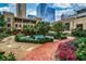 A garden path leads to a community pool nestled among lush greenery and flowering plants at 3376 Peachtree Ne Rd # 56, Atlanta, GA 30326