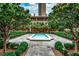 Beautiful community pool surrounded by lush landscaping and trees, perfect for relaxing on a hot day at 3376 Peachtree Ne Rd # 56, Atlanta, GA 30326