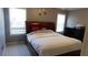 Bedroom with grey walls, carpet, dark wood bed, two windows, and dark wood dresser at 4845 Dartford Dr, Powder Springs, GA 30127