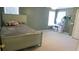 Bedroom with carpet, green walls, two windows, a bed, a desk, and a white door at 4845 Dartford Dr, Powder Springs, GA 30127