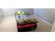 bedroom with grey walls, carpeted floor and a toddler bed with toys at 4845 Dartford Dr, Powder Springs, GA 30127