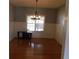 Charming dining room with hardwood floors, elegant chandelier, and bright natural light at 4845 Dartford Dr, Powder Springs, GA 30127
