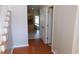 Inviting entryway with hardwood floors that transitions into a kitchen with a crystal chandelier and tile floor at 4845 Dartford Dr, Powder Springs, GA 30127