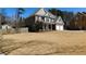 View of house featuring an expansive lawn, two-car garage and mature trees, ideal for outdoor enjoyment at 4845 Dartford Dr, Powder Springs, GA 30127