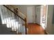 Bright foyer with hardwood floors, carpeted stairs, and a glimpse of the welcoming front entrance at 4845 Dartford Dr, Powder Springs, GA 30127