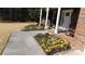 Inviting entryway with colorful flower beds, a brick-paved porch, and classic rocking chairs for relaxing at 4845 Dartford Dr, Powder Springs, GA 30127