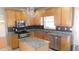 Kitchen with wood cabinets, granite countertops, stainless steel appliances and a decorative chandelier at 4845 Dartford Dr, Powder Springs, GA 30127
