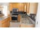 Close up of a kitchen featuring wood cabinets, granite countertops and backsplash, and stainless steel appliances at 4845 Dartford Dr, Powder Springs, GA 30127