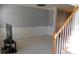 Cozy living room with carpet, wainscoting, a ceiling fan, and a staircase to the upper level at 4845 Dartford Dr, Powder Springs, GA 30127