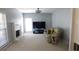 Bright living room featuring a painted brick fireplace, carpeted floors, a ceiling fan, and a recliner sofa at 4845 Dartford Dr, Powder Springs, GA 30127