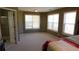 Generous main bedroom with neutral carpet and plenty of natural light from multiple windows at 4845 Dartford Dr, Powder Springs, GA 30127