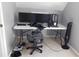 Office space with gaming monitors, fan, and a grey chair with a carpeted floor at 4845 Dartford Dr, Powder Springs, GA 30127
