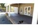 Covered patio with a tan vinyl siding exterior, recessed lighting, dark concrete floor, and brick landscaping at 4845 Dartford Dr, Powder Springs, GA 30127