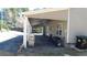 Covered patio with string lights, ceiling fan, tan siding, multiple grills, and a brick floor at 4845 Dartford Dr, Powder Springs, GA 30127