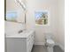 Bathroom featuring a toilet, vanity sink with countertop and window providing natural light at 561 Ashburton Ave, Decatur, GA 30032
