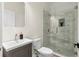Updated bathroom features frameless glass shower, modern vanity, and mosaic tile floors at 561 Ashburton Ave, Decatur, GA 30032