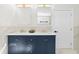 Bathroom featuring double sink vanity with undermount sinks, white countertop, and navy cabinets at 561 Ashburton Ave, Decatur, GA 30032