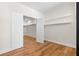 Bedroom with a walk-in closet, hardwood floors, and neutral paint color at 561 Ashburton Ave, Decatur, GA 30032