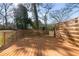 Large wooden deck with horizontal wood railing with views of the back yard at 561 Ashburton Ave, Decatur, GA 30032