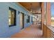 Spacious front porch featuring a wood floor, modern lighting fixtures, and elegant architectural details at 561 Ashburton Ave, Decatur, GA 30032