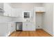 Updated kitchen features stainless steel dishwasher, quartz countertops, and white cabinets and tile at 561 Ashburton Ave, Decatur, GA 30032
