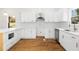 Updated kitchen features quartz countertops, white cabinets, stainless steel appliances, and hardwood floors at 561 Ashburton Ave, Decatur, GA 30032