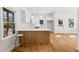 Bright kitchen boasts white cabinets, white subway tile backsplash, quartz countertops, and wood island at 561 Ashburton Ave, Decatur, GA 30032