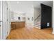 Open-concept living room with hardwood floors, kitchen island, and abundant natural light at 561 Ashburton Ave, Decatur, GA 30032