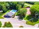 Aerial view of the community featuring a swimming pool, clubhouse, tennis court, and playground in a park-like setting at 613 Hemlock Ct, Villa Rica, GA 30180